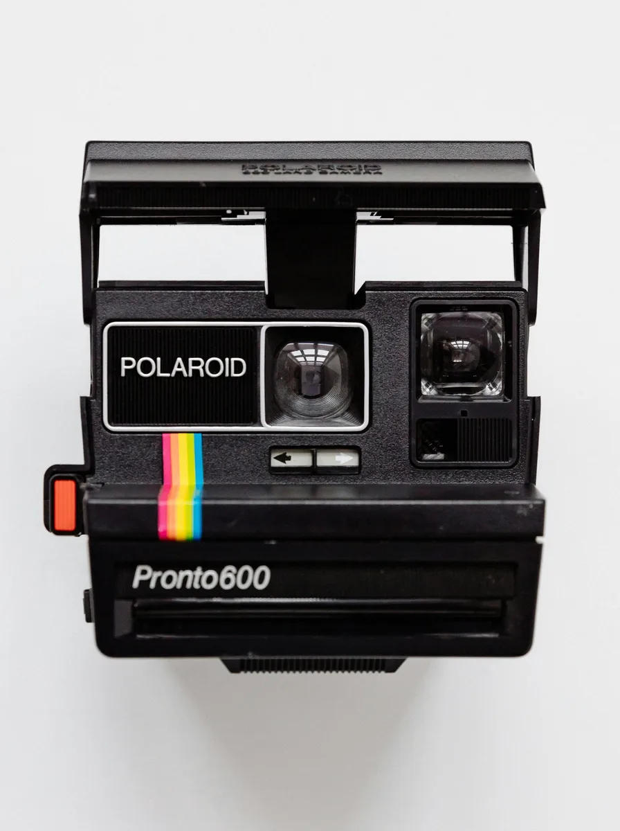 Before and after: a picture of an instant film camera turned into a DWG line drawing